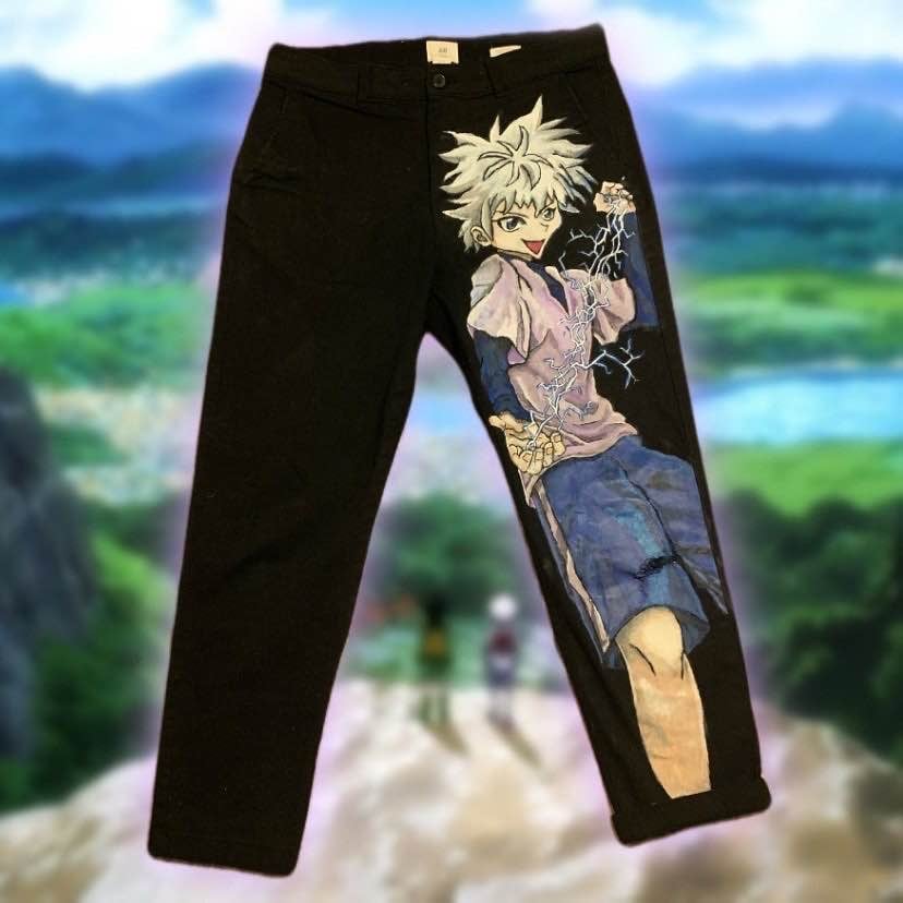 Black pants with anime character design featuring blonde spiky-haired boy graphic on front leg