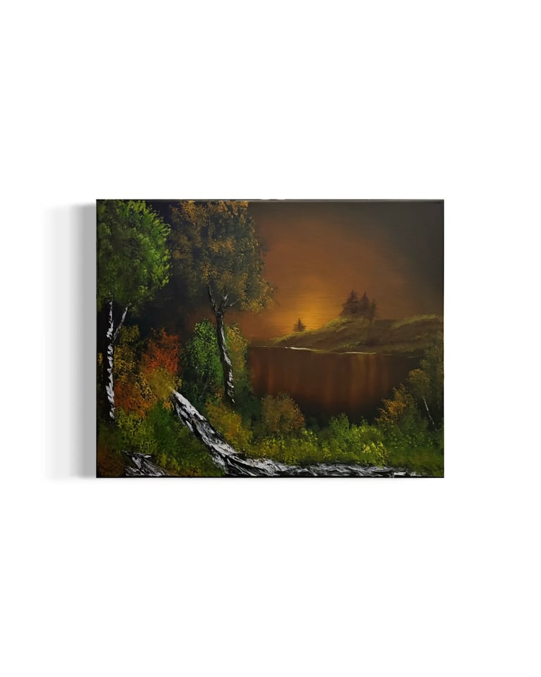 Canvas art print depicting a moody landscape with golden sunset over a distant lake, framed by dark green trees and a birch tree trunk in the foreground