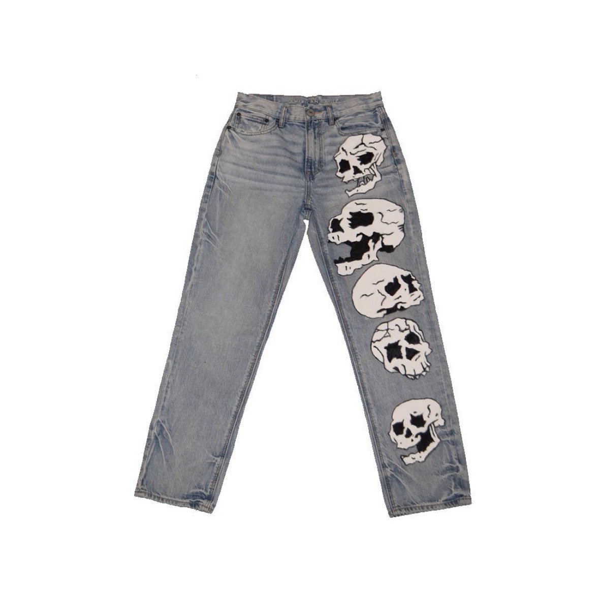 Gray jeans with five skull graphic prints down the right leg