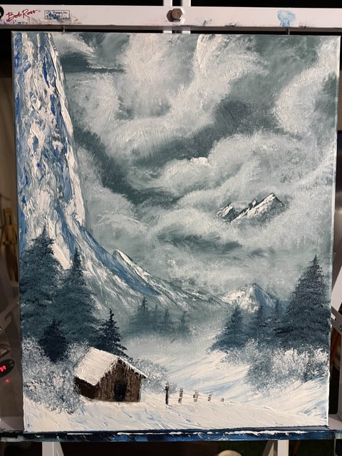 Winter mountain landscape with snow-covered peaks, tall cliff, evergreen trees, wooden cabin, and figures walking on snowy valley floor
