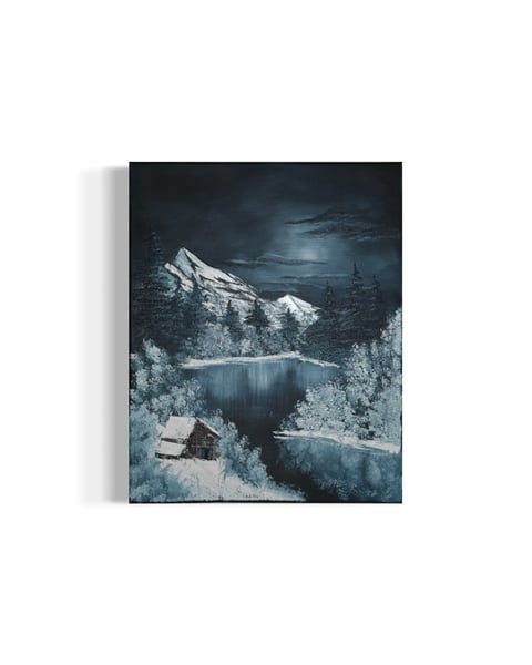 Canvas print of a snowy mountain landscape with a frozen lake, pine trees, and cabin under moonlight