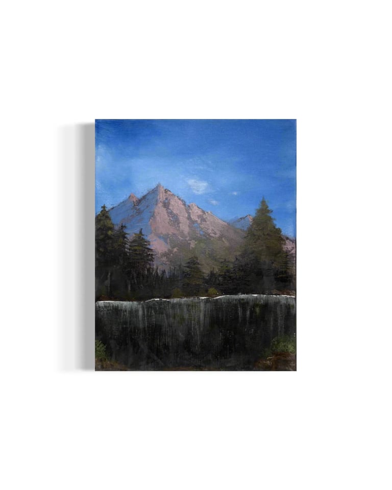 Canvas print of a mountain landscape with a snow-capped peak, evergreen forest, and clear blue sky
