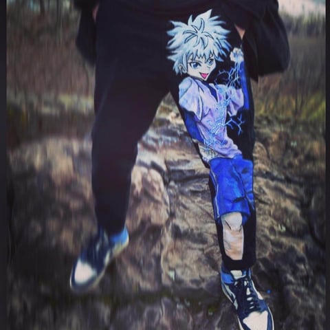 Anime character with spiky white hair wearing blue outfit, running outdoors on a rocky path near a person in dark clothing